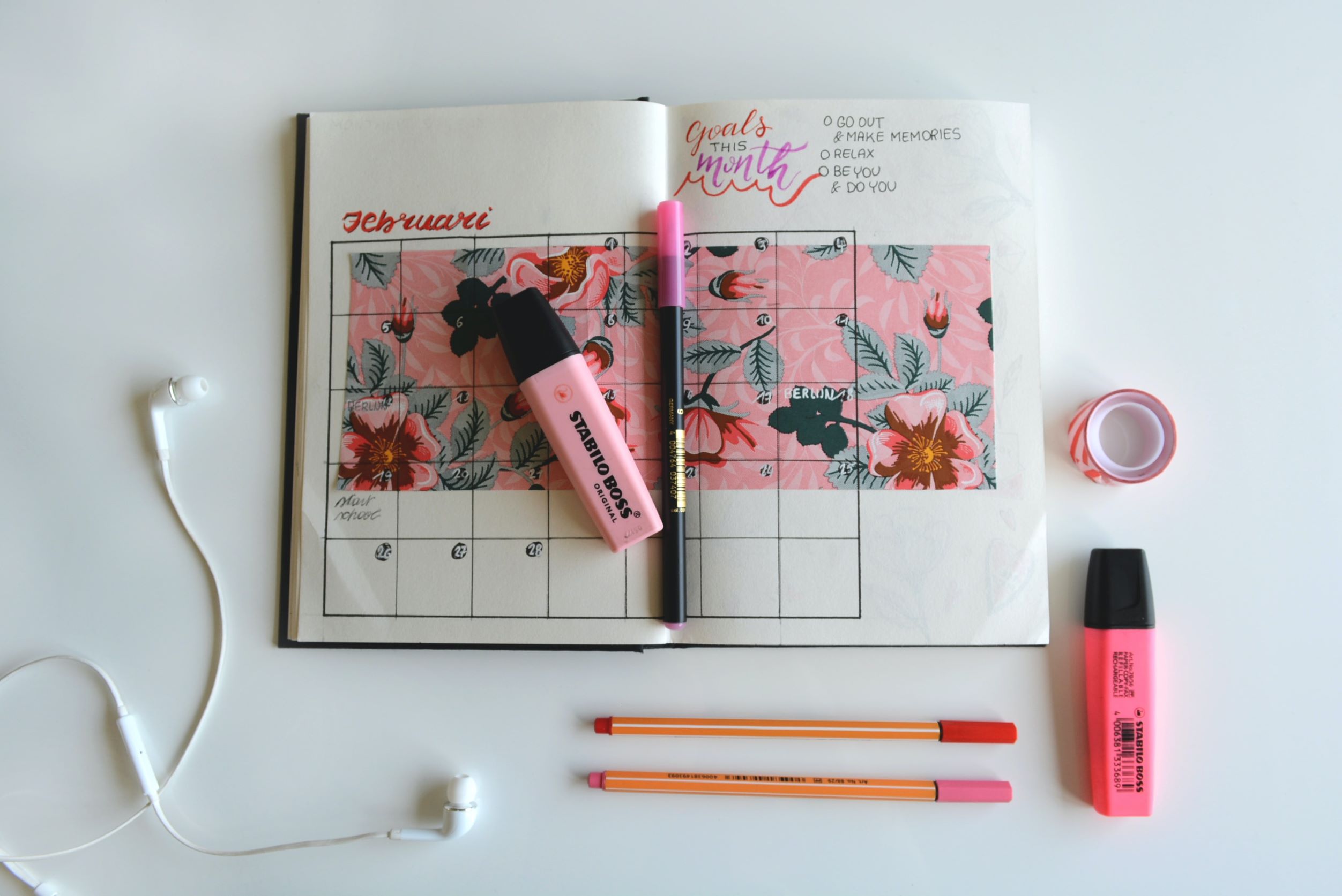 Pink planner, pens, highlighters and washi tape